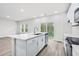 Open concept kitchen with island, white cabinets, and stainless steel appliances at 3539 Rayner Cove Ct., Little River, SC 29566