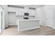 Open concept kitchen with white cabinets, island, and stainless steel appliances at 3539 Rayner Cove Ct., Little River, SC 29566