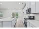 Modern kitchen with white cabinets, quartz countertops, and stainless steel appliances at 3539 Rayner Cove Ct., Little River, SC 29566