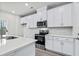 Modern kitchen, white cabinets, quartz countertops, stainless steel appliances at 3539 Rayner Cove Ct., Little River, SC 29566