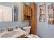 Clean bathroom with wood cabinets and a shower at 6001 S Kings Hwy., Myrtle Beach, SC 29575