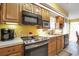 Kitchen with wood cabinets, stainless steel appliances, and an eat-in area at 6001 S Kings Hwy., Myrtle Beach, SC 29575