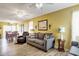 Living room with gray sofa, and access to the dining area at 6001 S Kings Hwy., Myrtle Beach, SC 29575