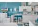 Bright white kitchen with teal accents and breakfast bar at 6803 N Ocean Blvd. # 230, Myrtle Beach, SC 29572