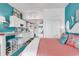 Bedroom with coral bedding and teal accents, open to kitchen at 6803 N Ocean Blvd. # 230, Myrtle Beach, SC 29572