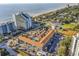 Aerial view showing a complex near the beach with a pool and parking at 6803 N Ocean Blvd. # 230, Myrtle Beach, SC 29572