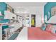 Main bedroom with coral bedding and teal accents, open to kitchen at 6803 N Ocean Blvd. # 230, Myrtle Beach, SC 29572