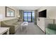Living area featuring sofa, chairs, and flat-screen TV at 2301 Ocean Blvd. S # 1218, Myrtle Beach, SC 29577