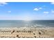 Oceanfront beach view with beach umbrellas and people at 7100 N Ocean Blvd. # 913, Myrtle Beach, SC 29572