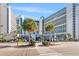 Oceanfront resort building with palm trees and walking path at 7100 N Ocean Blvd. # 913, Myrtle Beach, SC 29572