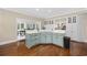 Kitchen features light blue cabinetry, white countertops, and hardwood floors at 4400 Saint Andrews Ct., Murrells Inlet, SC 29576