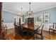 Formal dining room with hardwood floors, chandelier, and large windows at 4400 Saint Andrews Ct., Murrells Inlet, SC 29576