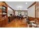 Spacious home office with built-in shelving, hardwood floors, and large windows at 4400 Saint Andrews Ct., Murrells Inlet, SC 29576