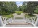 View from porch stairs, showcasing a circular driveway and landscaping at 4400 Saint Andrews Ct., Murrells Inlet, SC 29576