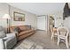 Open living area with sofa, dining table, and hardwood floors at 1501 Ocean Blvd. S # 1140, Myrtle Beach, SC 29577