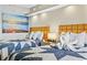 Condo bedroom with two beds, ocean art, and kitchenette view at 1501 Ocean Blvd. S # 1140, Myrtle Beach, SC 29577
