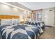 Two double beds in a condo bedroom with ocean view art at 1501 Ocean Blvd. S # 1140, Myrtle Beach, SC 29577