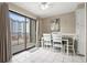 Dining area with white table and chairs, slider to balcony and ocean view at 5905 South Kings Hwy. # A246, Myrtle Beach, SC 29575