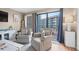Living room with two striped armchairs, a view of the ocean, and a sliding glass door at 5905 South Kings Hwy. # A246, Myrtle Beach, SC 29575