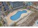 Aerial view of a kidney-shaped pool with surrounding lounge chairs and building at 5905 South Kings Hwy. # A246, Myrtle Beach, SC 29575