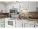 Modern kitchen with white cabinets, granite counters, and stainless steel appliances at 5905 South Kings Hwy. # A246, Myrtle Beach, SC 29575