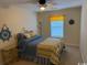 Charming bedroom with a ceiling fan, window seating and white bed frame at 1188 Fairway Ln. # 7, Conway, SC 29526