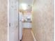 Hallway with beige walls, tiled floor, and views of kitchen and bedroom at 1100 Commons Blvd. # 107, Myrtle Beach, SC 29572