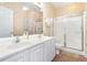 Bathroom with double sinks and a walk-in shower at 1100 Commons Blvd. # 107, Myrtle Beach, SC 29572
