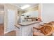 Kitchen with white cabinets and breakfast bar with seating at 1100 Commons Blvd. # 107, Myrtle Beach, SC 29572