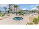 Community pool and hot tub surrounded by lush landscaping at 1100 Commons Blvd. # 107, Myrtle Beach, SC 29572