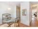 Dining area with a round glass table, chairs, and view into hallway at 1100 Commons Blvd. # 107, Myrtle Beach, SC 29572