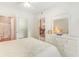 Main bedroom with white dresser and ensuite bathroom at 1100 Commons Blvd. # 107, Myrtle Beach, SC 29572