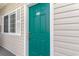 Teal front door with white trim and shutters, welcoming condo entrance at 1100 Commons Blvd. # 107, Myrtle Beach, SC 29572