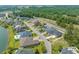 Aerial view showcasing a residential neighborhood with houses and a lake at 205 Waterfall Circle, Little River, SC 29566