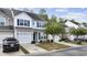 Attractive row of townhouses with gray siding and landscaping at 160 Freeboard Ln. # 802, Carolina Shores, NC 28467