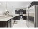 Modern kitchen features granite countertops, stainless steel appliances, and dark wood cabinets at 160 Freeboard Ln. # 802, Carolina Shores, NC 28467