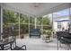 Relaxing screened porch with seating and ceiling fan at 160 Freeboard Ln. # 802, Carolina Shores, NC 28467