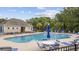 Community pool with lounge chairs, tables, and umbrellas at 160 Freeboard Ln. # 802, Carolina Shores, NC 28467