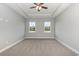 Well-lit bedroom featuring neutral walls, carpet flooring, and two large windows at 650 Timber Creek Dr., Loris, SC 29569