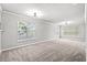Spacious living room with neutral carpeting and large windows at 4273 Villas Dr. # 1007, Little River, SC 29566