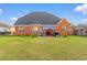 Brick house with patio, grill, and spacious grassy backyard at 505 Quincy Hall Dr., Myrtle Beach, SC 29579
