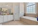Bathroom with a bathtub, vanity, and large window at 505 Quincy Hall Dr., Myrtle Beach, SC 29579