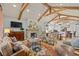 Spacious living room features exposed wooden beams, stone fireplace, and comfortable seating at 3601 Ocean Blvd. N, Myrtle Beach, SC 29577