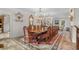 Bright dining room features a long wooden table and crystal chandelier at 3601 Ocean Blvd. N, Myrtle Beach, SC 29577