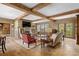 Elegant living room boasts hardwood floors, exposed beams, and a stone fireplace at 3601 Ocean Blvd. N, Myrtle Beach, SC 29577