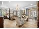 Luxurious main bedroom with a four-poster bed, sitting area, and fireplace at 3601 Ocean Blvd. N, Myrtle Beach, SC 29577