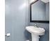 Powder room with pedestal sink and dark framed mirror at 2248 Beauclair Ct., Myrtle Beach, SC 29579