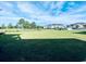 Spacious grassy backyard with a view of condo buildings and trees at 4819 Orchid Way # 104, Myrtle Beach, SC 29577