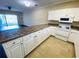 Spacious kitchen with an abundance of white cabinetry and granite countertops at 4819 Orchid Way # 104, Myrtle Beach, SC 29577