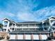Three-story building with multiple garages and balconies at 4819 Orchid Way # 104, Myrtle Beach, SC 29577